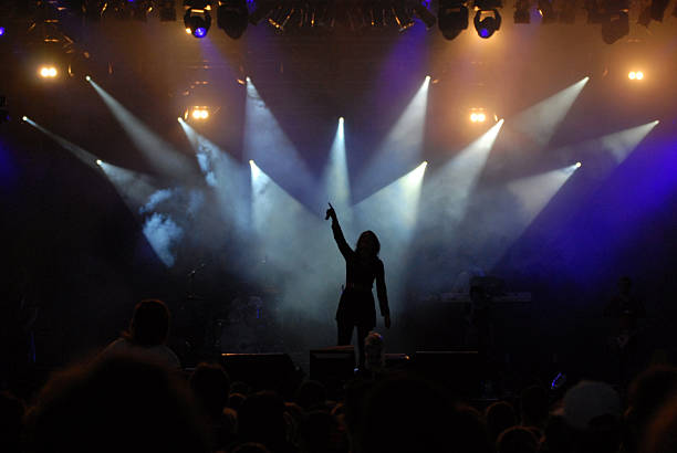 istock Silhouette of singer performing on stage under spotlights 172159064