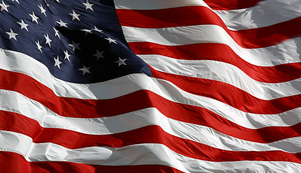 United States of America Flag. American flag in the wind. See one more angle of this image.please view other similar images. flag backdrop stock pictures, royalty-free photos & images