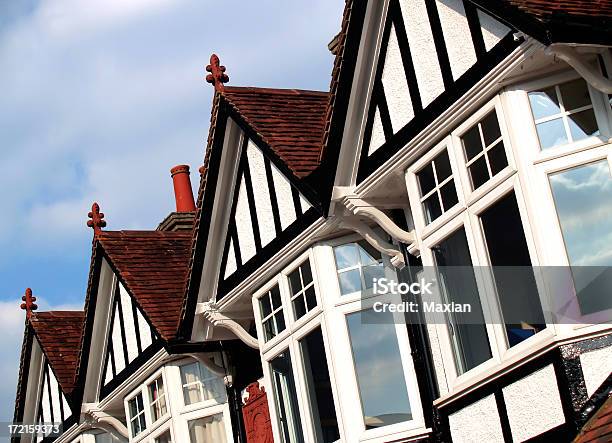 Line Of Bay Windowed Cottage Homes Against Blue Sky Stock Photo - Download Image Now
