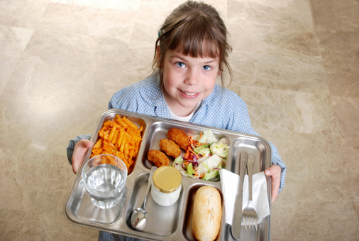 Six year old schoolgirl with her lunch on a tray.School luch (Direct links)