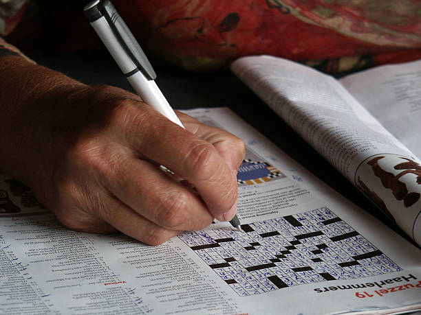 Close up Senior hand Solving puzzle stock photo