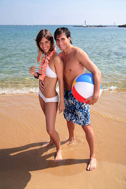 para praia. - swimming trunks women beach ball couple - fotografias e filmes do acervo