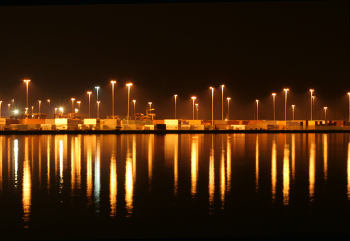 a shot of a container port full of containers ready to be shipped all around the world