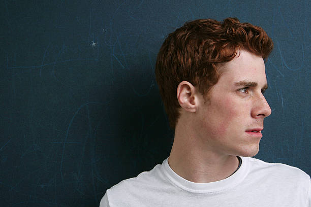 Head and Shoulders shot of Male Teen Looking Sideways stock photo