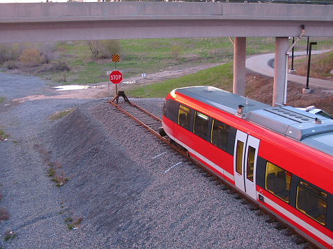 A train comes to the end of the line. Sunset adds a warm glow to the image.