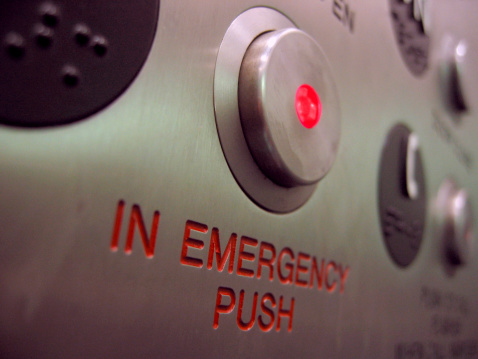 A close up shot of an emergency stop button on an elevator