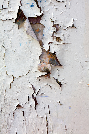 Peeling paint on an old wood-sided house