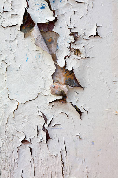 Closeup wall section with heavy peeling white paint stock photo