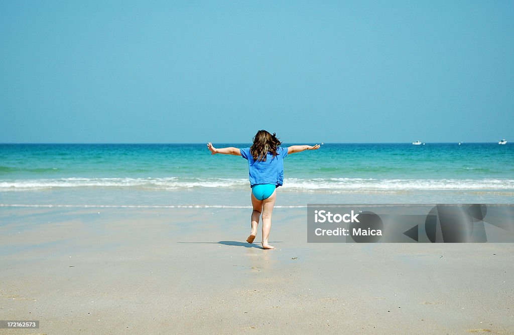 Freedom Five years old running to the sea.Summer Dreams Lightbox: Arms Outstretched Stock Photo