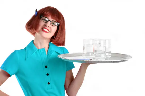 A retro-looking waitress with a tray of water glasses.