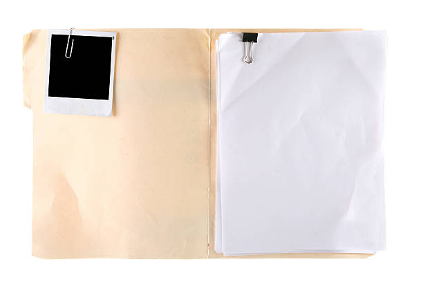 Manila Folder with Blank Photo and Documents Photo of an open manila folder. Folder and objects show wear and tear for a gunge look. Photo attached with paper clip on the left and stack of papers on the right. You add the picture and the case details. Designers should have fun with this one. manila folder and paper clip stock pictures, royalty-free photos & images