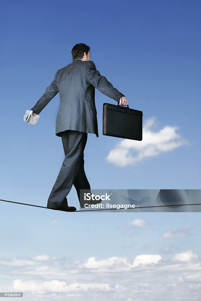 Sky is the limit Businessman on a tightrope. Adult Stock Photo