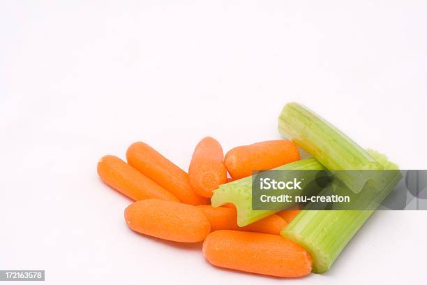 Baby Carrots And Chopped Celery On White Background Stock Photo - Download Image Now