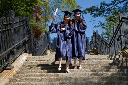 Female graduates in park