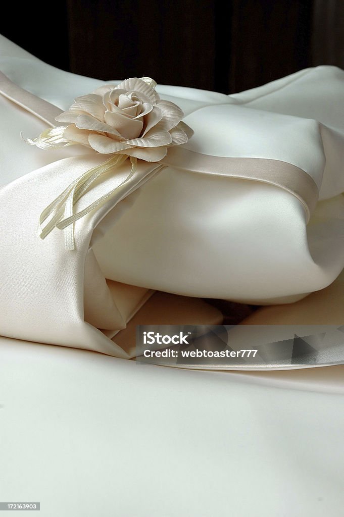 Pretty Wedding Dress Macro of simple white wedding dress with flower. Beauty Stock Photo