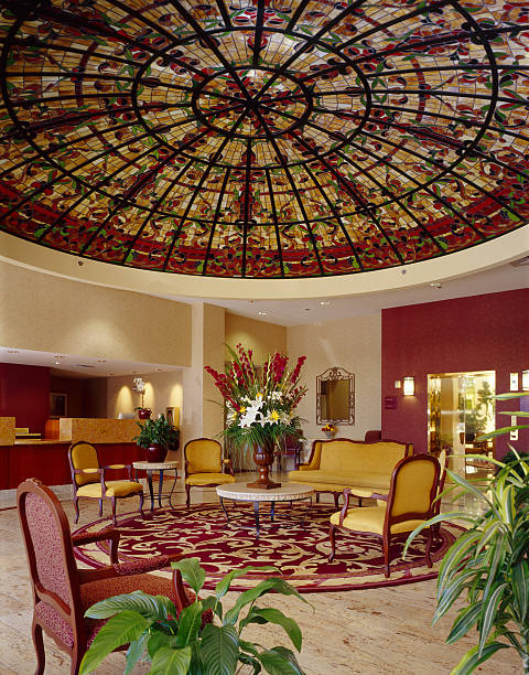 Elegant Hotel Lobby with Stained Glass Ceiling stock photo