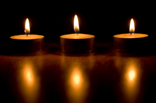 3 Tealight candles on a wooden table