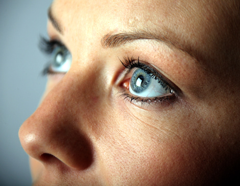 A close up of a young woman's blue eyes