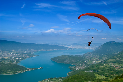 Paragliders on top of the Annecy lake, at the \