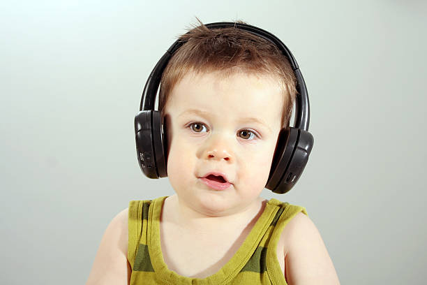 little boy with headphones stock photo