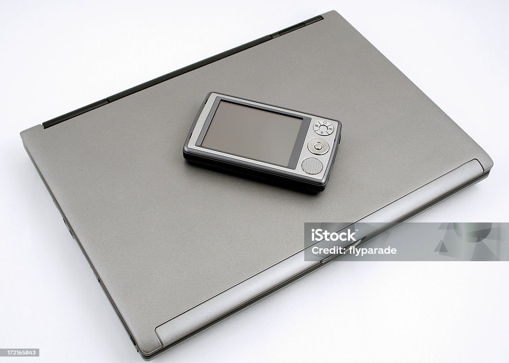 Palm and notebook Pocket PC on top of a notebook Advice Stock Photo