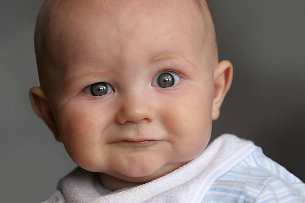 Baby Expressions Portrait of a baby with a curious expression! frowning stock pictures, royalty-free photos & images