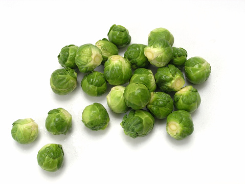 Arrangement of brussels sprouts on white background.