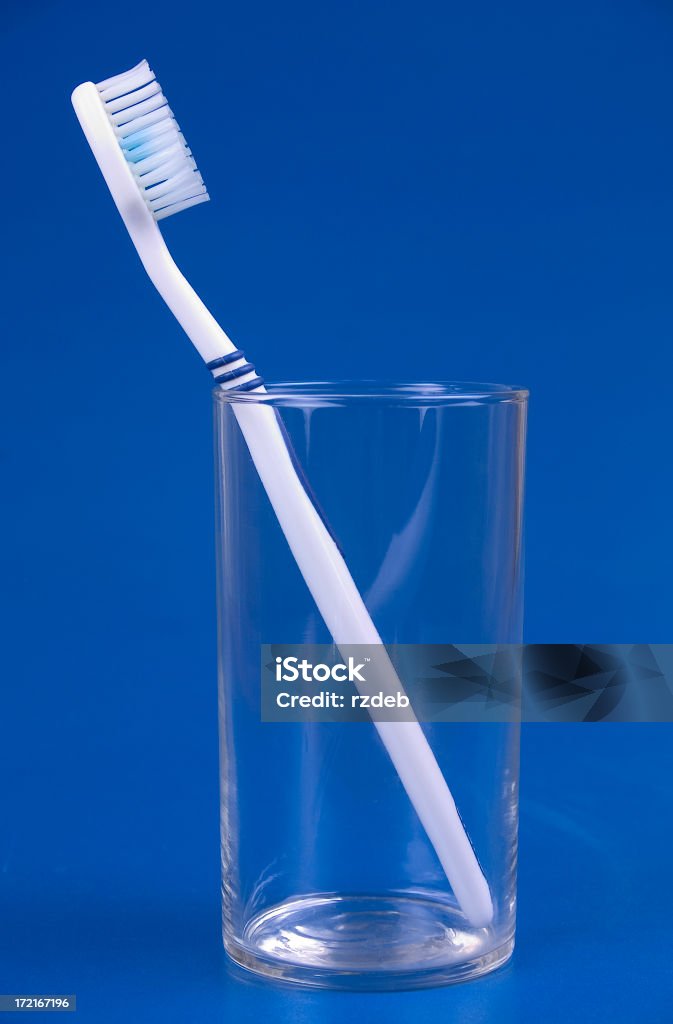 Toothbrush in glass "Toothbrush in glass, blue bakground," Bathroom Stock Photo