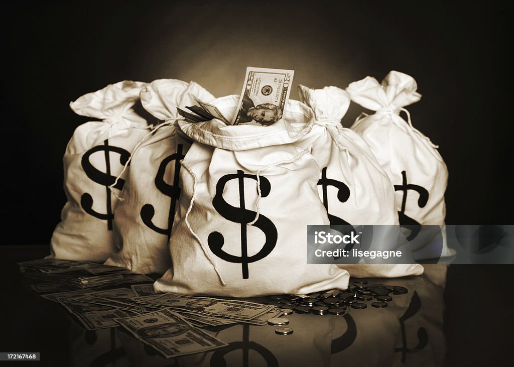 Money bags Money bags in sepia and grain. http://www.lisegagne.com/images/business.jpg Money Bag Stock Photo