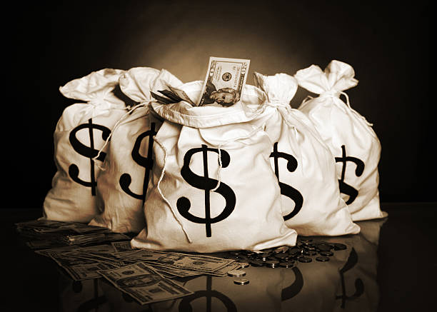 Money bags Money bags in sepia and grain. http://www.lisegagne.com/images/business.jpg money bag stock pictures, royalty-free photos & images