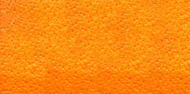 Close up of an orange's skin.