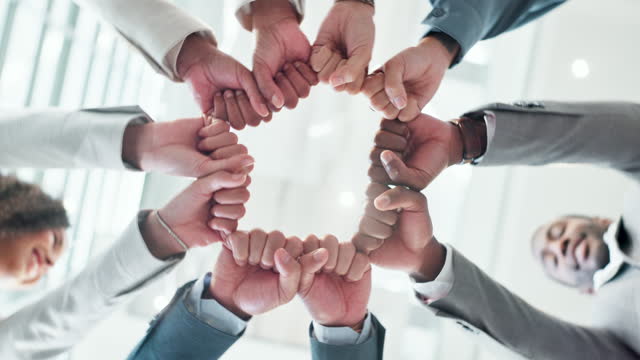 Business people, hands and fist bump for motivation, collaboration and corporate solidarity, teamwork or support. Mission, group workflow and synergy or diversity in integration sign and circle below