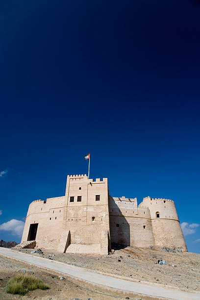 Desert Fortress United Arab Emirates "Fujairah Fort against deep blue sky, City of Fujairah,UAE" fujairah stock pictures, royalty-free photos & images