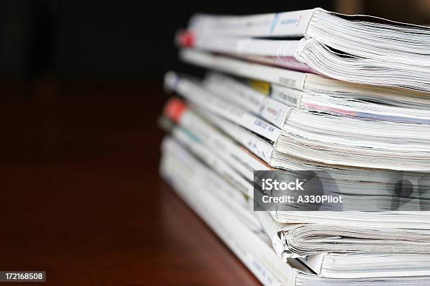 Stack Of Magazines Over A Wooden Desk Stock Photo - Download Image Now - Magazine - Publication, Stack, Book