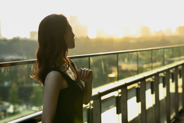 istock Young beautiful woman relaxing at sunset balcony 1721687633