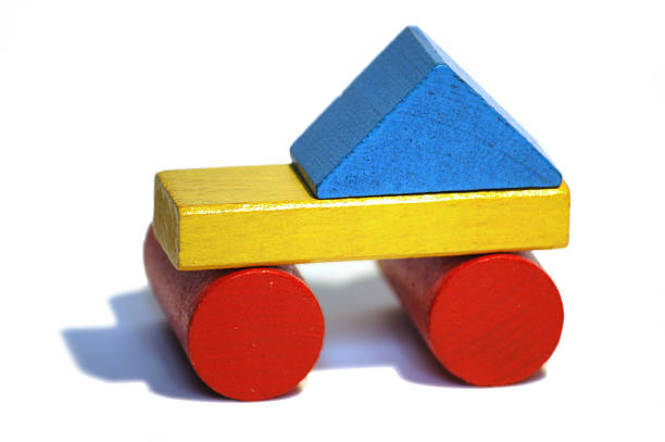a car made of wooden coloured blocks' buildings. it could be used for metaphorical scenarios.