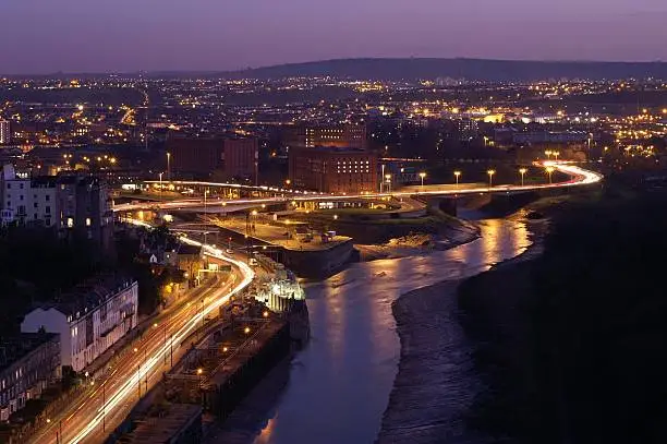 The entrance to Bristol harbour at dusk. Hotwells is to the left and Bedminster to the right. Time exposure so there are headlight trails. Taken from the Clifton Suspension Bridge over Avon Gorge.