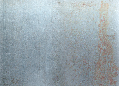 High resolution scan of worked-in steel. Smooth metal is clearly roughened in areas with sharp scratches, stains and rusting.