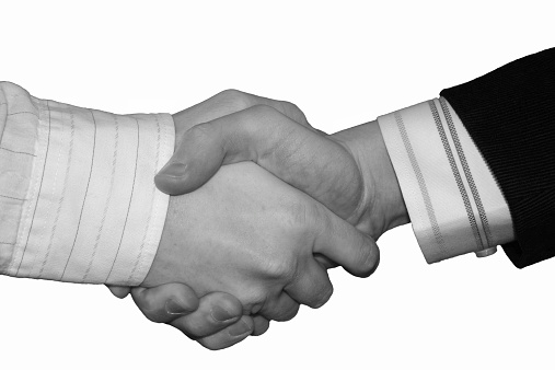 Handshake of steel hands. Deal gesture