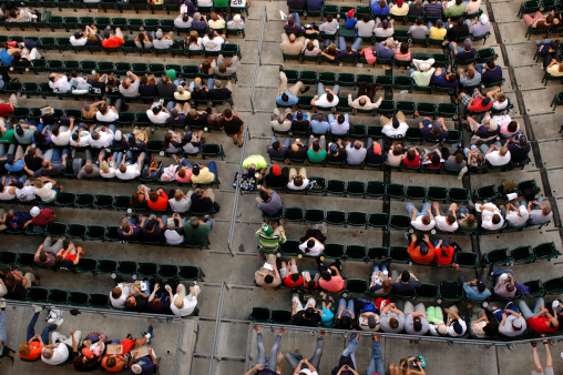 Shot from above a crowd watching a baseball game.