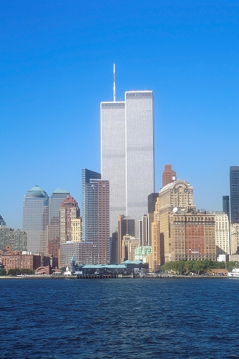 Archival and historical Twin Towers of World Trade Center in foreground from Hudson River. Skyline of Manhattan, New York Cityscape, United States. Vertical shot.