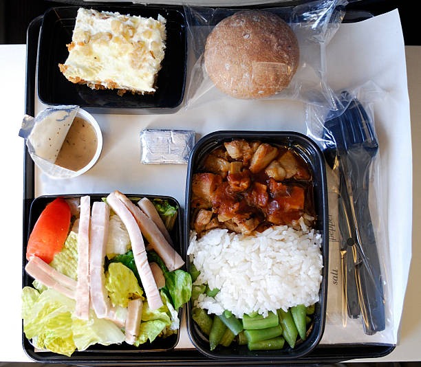 Dinner on an airplane Tray of food from airline travel. airplane food stock pictures, royalty-free photos & images