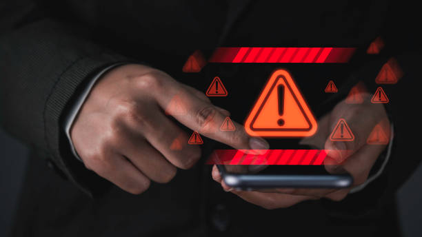istock Caution triangle warning sign displayed on a laptop screen, with a businessman or IT staff  programmer, developer using the computer to address a notification, error 404 problem concept 1721719916