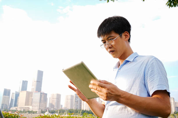 istock A man uses a tablet computer on the side of the road 1721721654