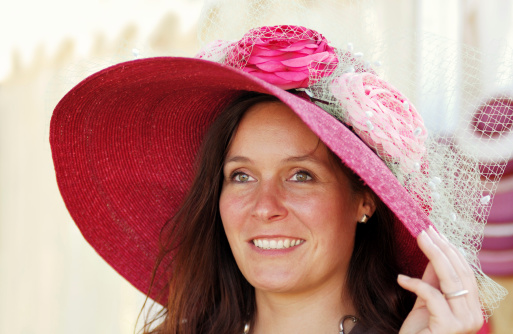 woman wearing an elegant victorian style hat also known as easter bonnet
