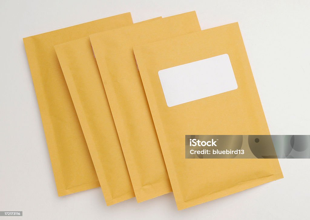 Manila envelopes 4 manila envelopes. Delivering Stock Photo
