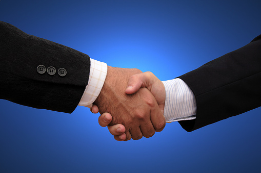 close up.handshake of business partners on a dark background.