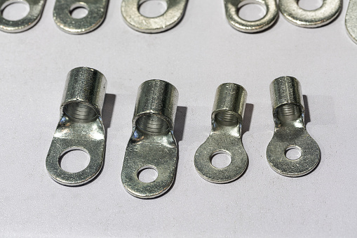 Different metal bolts and nuts on white background, top view