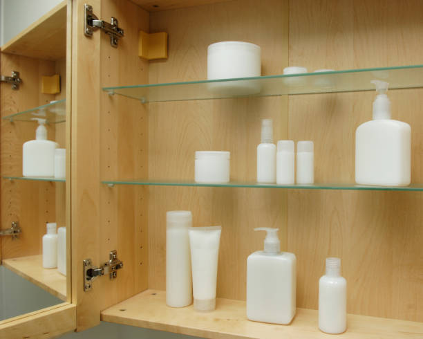 cosmetics in cabinet various blank generic cosmetic bottles in wooden and glass cabinet white plastic tube stock pictures, royalty-free photos & images