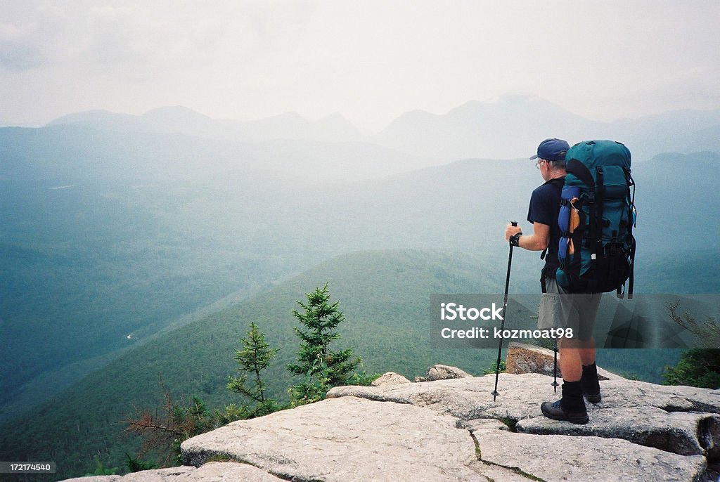 Appalachian Trail Hiker (The Journey) A backpacker views mountains to be travelled in New Hampshire on his 3500 km. (6 month) journey along the Appalachian Trail in the eastern United States, a marked footpath from Maine to Georgia through the Appalachian mountain range. Appalachian Trail Stock Photo